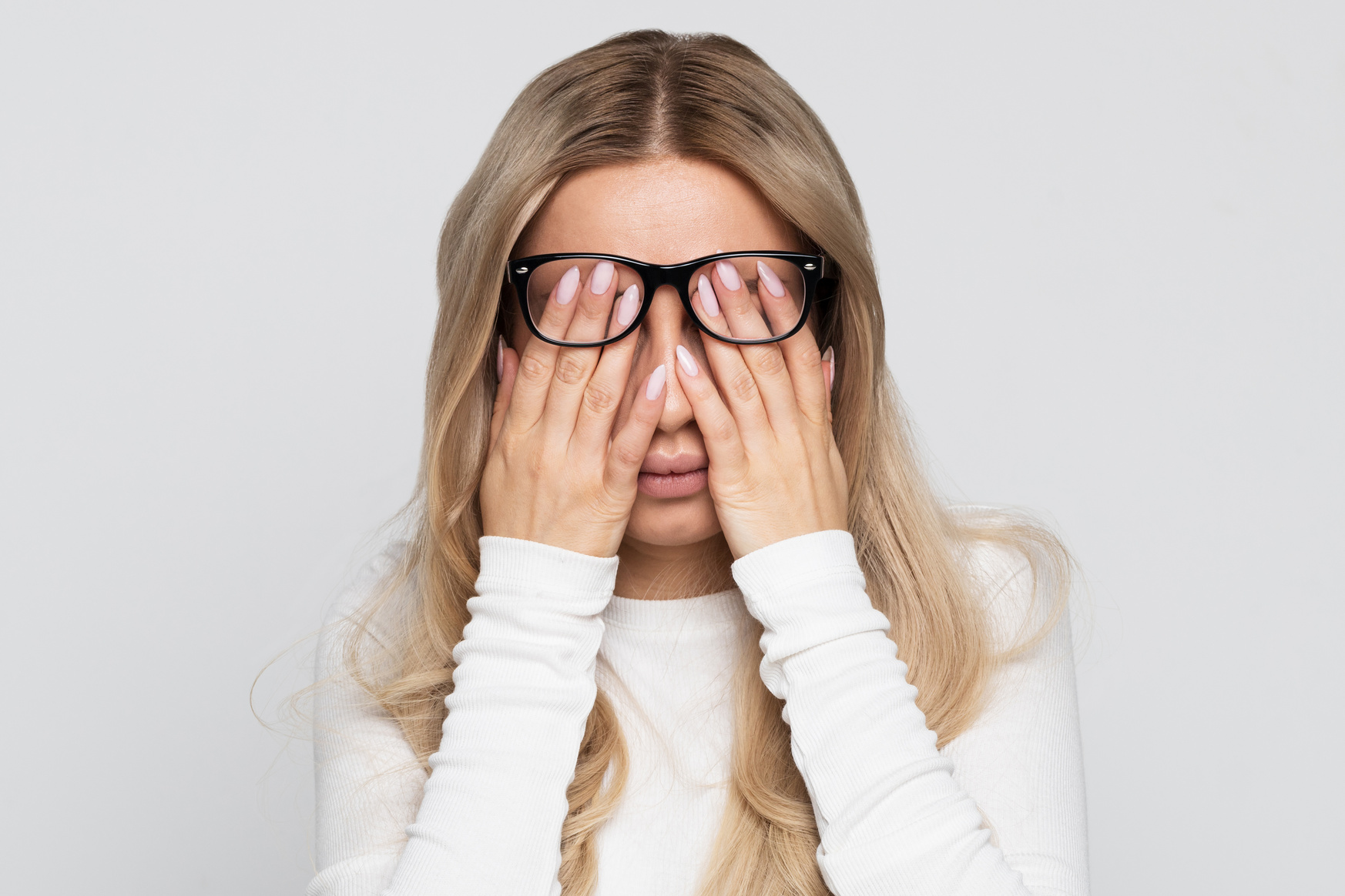Woman in Eyeglasses Rubbing Her Eyes